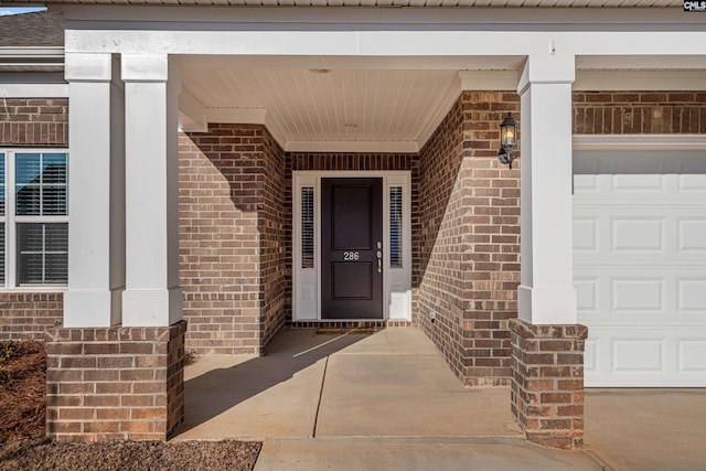 view of exterior entry with a garage