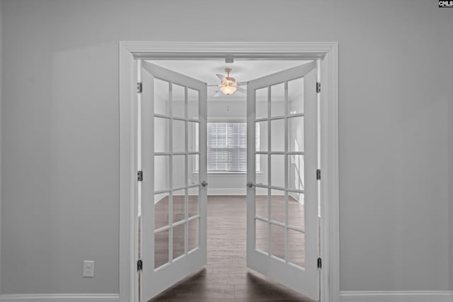 interior space with dark hardwood / wood-style flooring, french doors, and ceiling fan