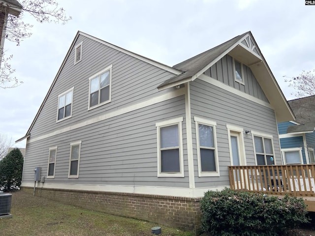 view of side of home with a wooden deck