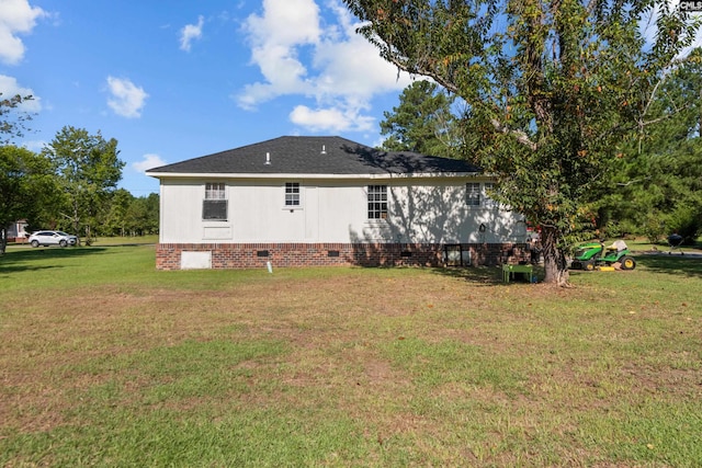 rear view of property featuring a lawn