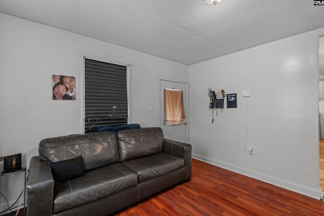 living room with hardwood / wood-style flooring and a textured ceiling