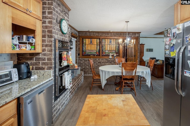 dining space with crown molding, dark wood-type flooring, a textured ceiling, and brick wall