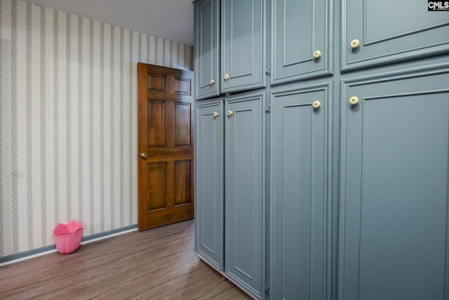 mudroom with light hardwood / wood-style flooring and a textured ceiling