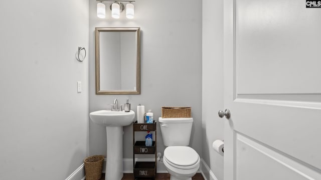 bathroom featuring sink and toilet