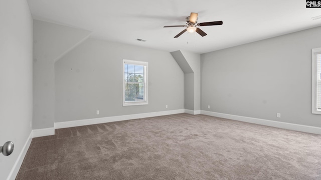 bonus room featuring lofted ceiling, carpet floors, and ceiling fan