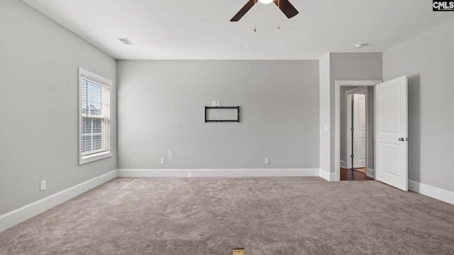 empty room with ceiling fan and carpet flooring