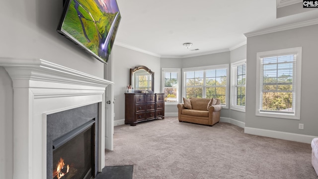 sitting room featuring ornamental molding and light carpet