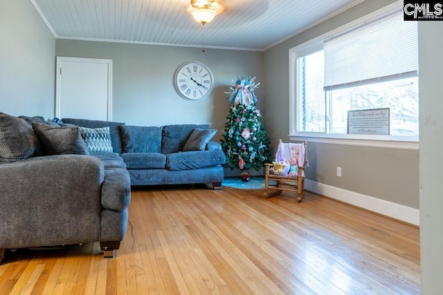 living room with hardwood / wood-style flooring and crown molding