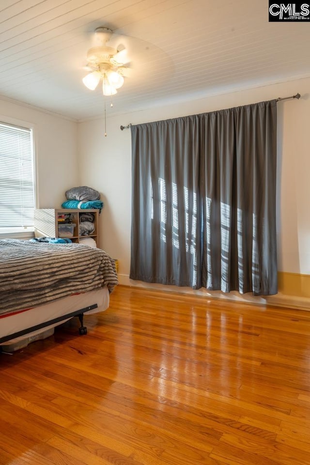 bedroom with crown molding and light hardwood / wood-style flooring