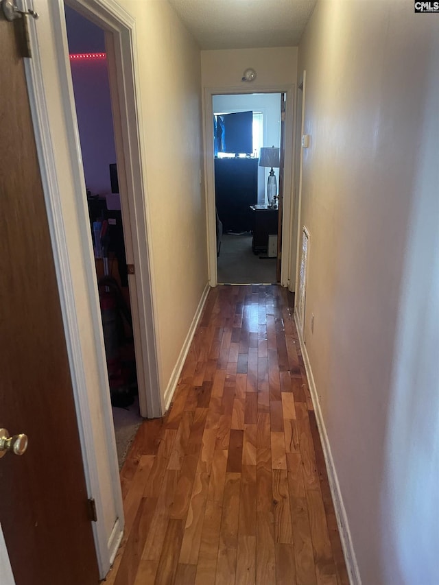 hallway featuring dark hardwood / wood-style flooring