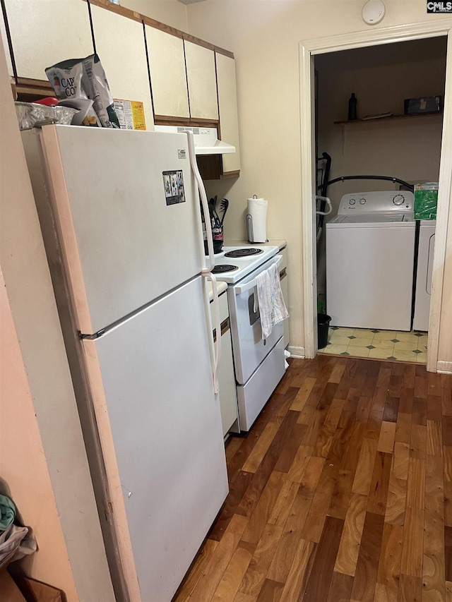 kitchen featuring dark hardwood / wood-style flooring, white appliances, separate washer and dryer, and white cabinetry