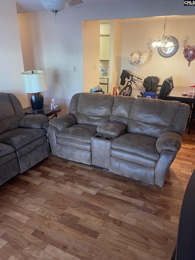 living room featuring hardwood / wood-style floors and a notable chandelier