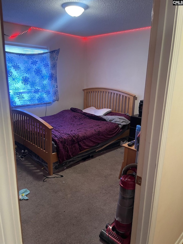 bedroom featuring carpet floors and a textured ceiling