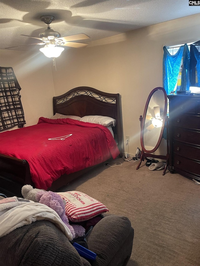 bedroom featuring ceiling fan, carpet flooring, and a textured ceiling