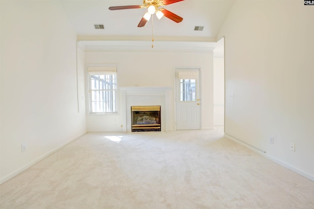 unfurnished living room with vaulted ceiling, light carpet, ceiling fan, and a fireplace