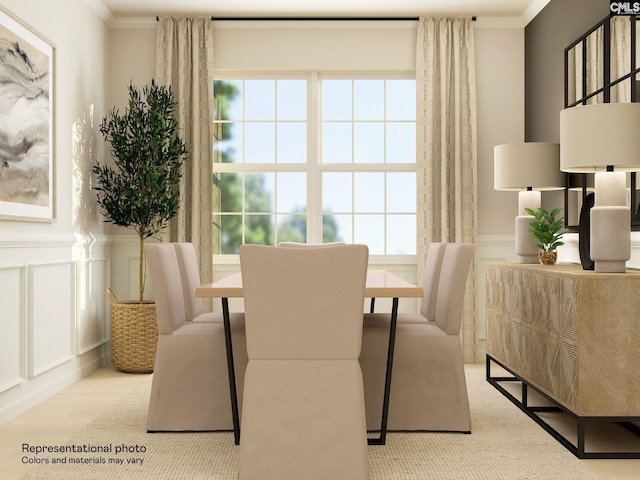 dining room featuring crown molding and light wood-type flooring