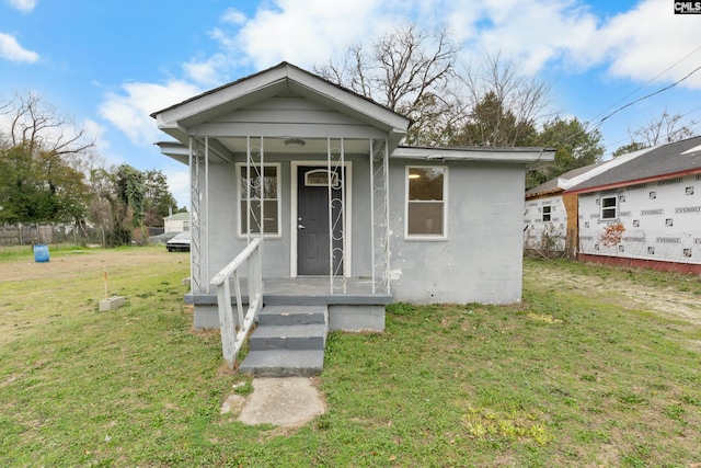 bungalow-style home featuring a front lawn