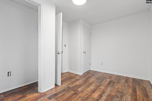 unfurnished bedroom with dark hardwood / wood-style flooring