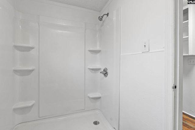 bathroom featuring hardwood / wood-style floors and walk in shower