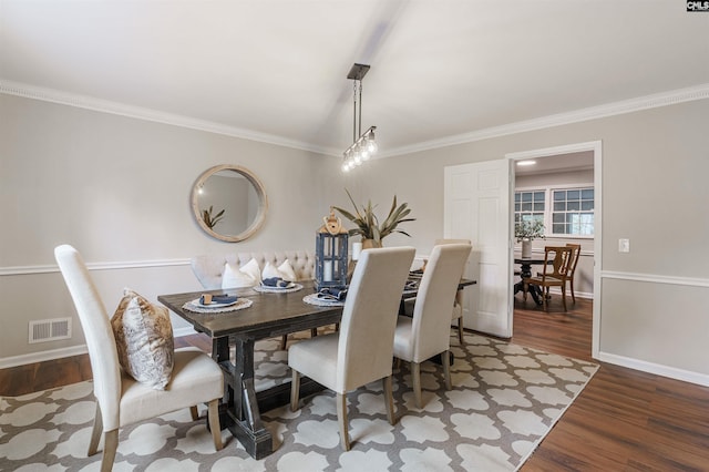 dining room featuring crown molding and dark hardwood / wood-style flooring