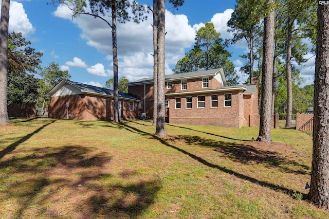 back of house featuring a yard