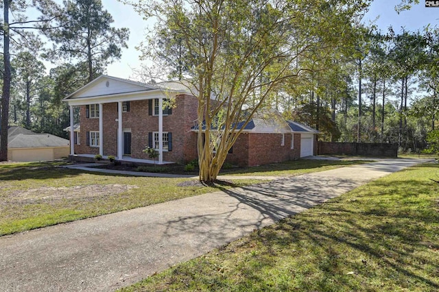 greek revival house with a garage and a front yard