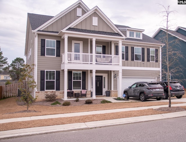 craftsman-style home featuring a garage, a balcony, and covered porch