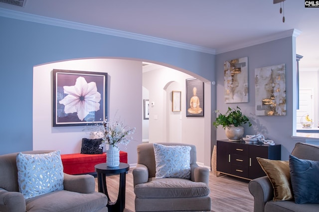 living room featuring ornamental molding and light hardwood / wood-style flooring