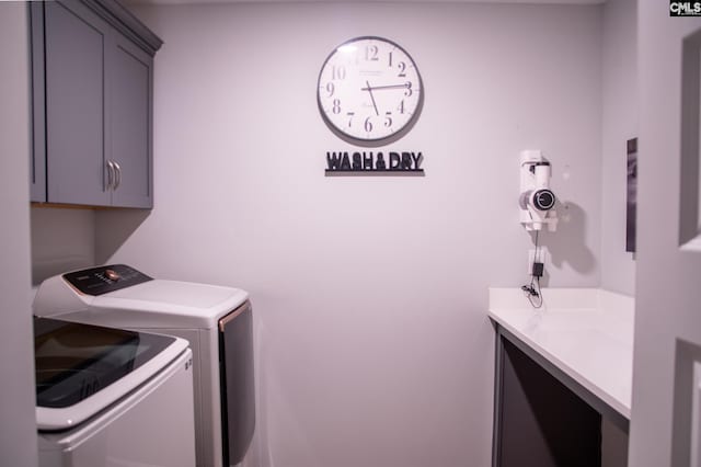 laundry area with cabinets and independent washer and dryer