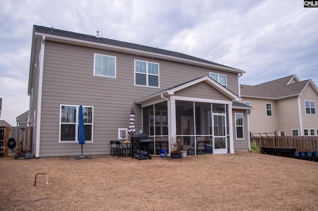 back of property with a sunroom