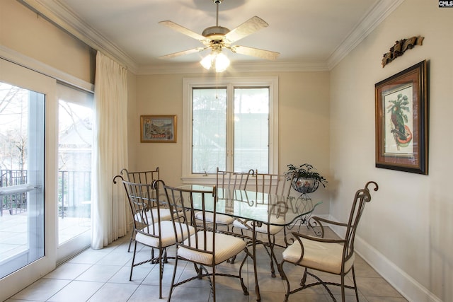 tiled dining space featuring ceiling fan and ornamental molding