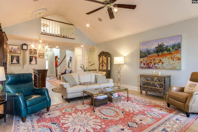 living room featuring crown molding, ceiling fan, and light wood-type flooring