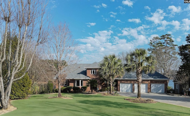 view of front of property featuring a garage and a front yard