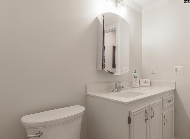 bathroom featuring vanity, ornamental molding, and toilet