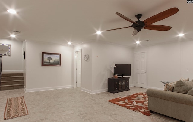 living room with ceiling fan and ornamental molding