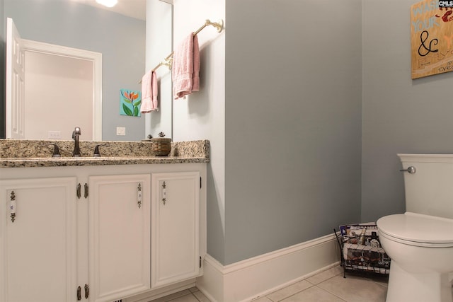 bathroom with vanity, toilet, and tile patterned flooring