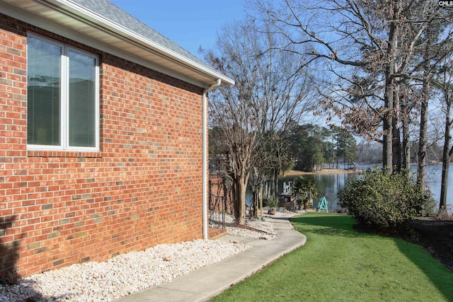 view of side of property with a yard