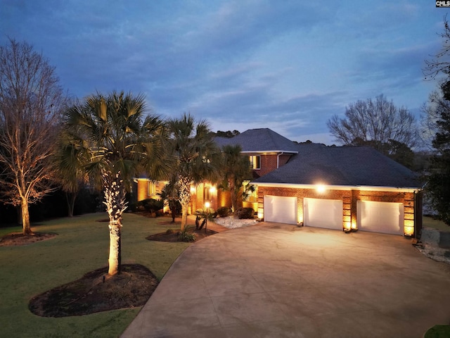 view of front facade with a garage and a lawn