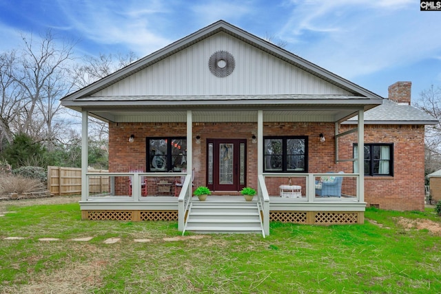 view of front of house with a porch and a front lawn