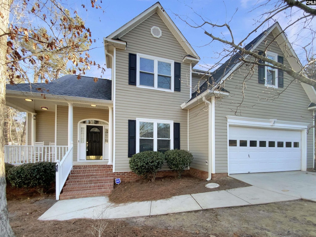 front facade featuring a porch and a garage