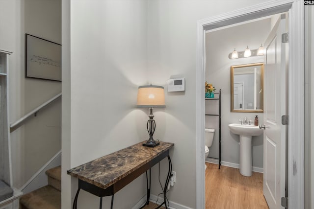 bathroom with sink, hardwood / wood-style flooring, and toilet