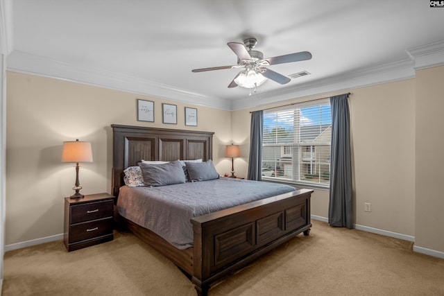 carpeted bedroom with ceiling fan and ornamental molding