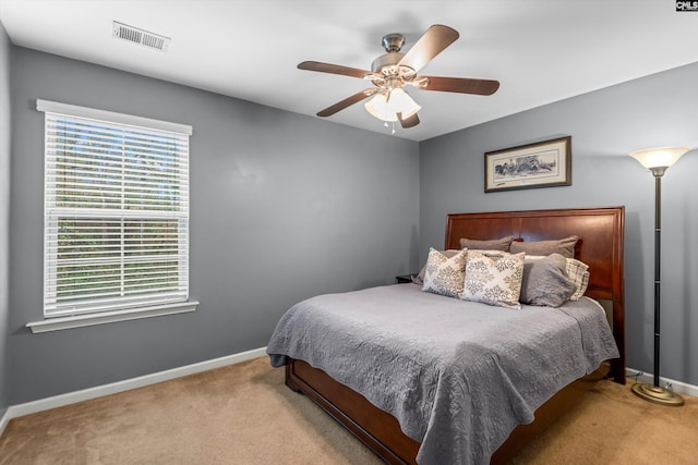 bedroom featuring ceiling fan and light carpet