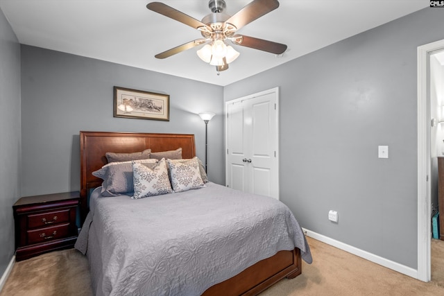 carpeted bedroom with a closet and ceiling fan