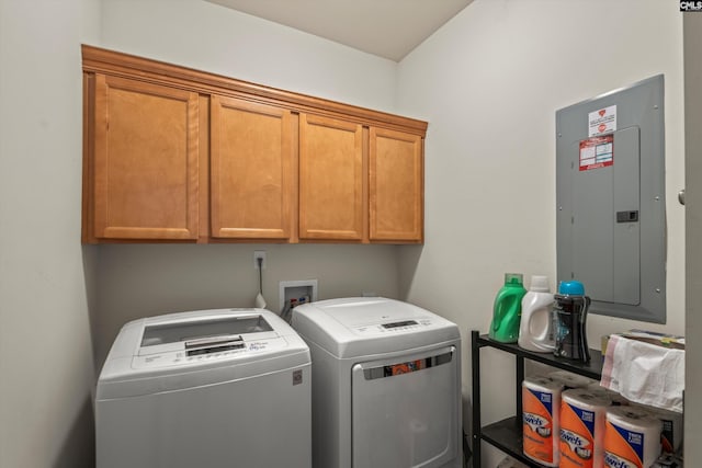 laundry room featuring cabinets, electric panel, and independent washer and dryer