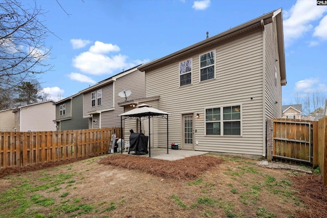 rear view of house featuring a gazebo and a patio area