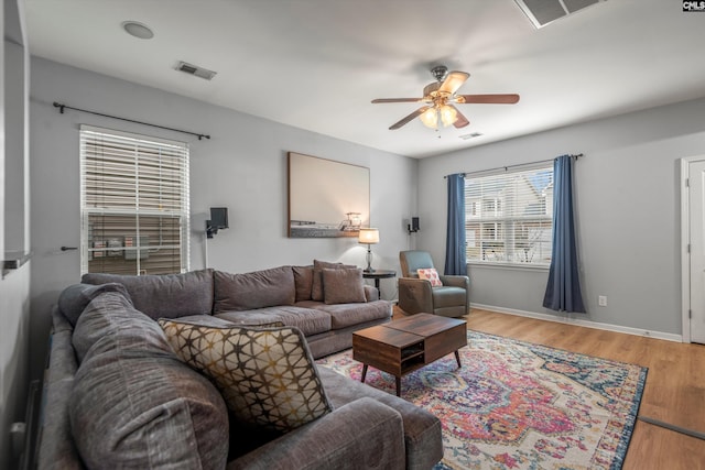 living room featuring hardwood / wood-style flooring and ceiling fan