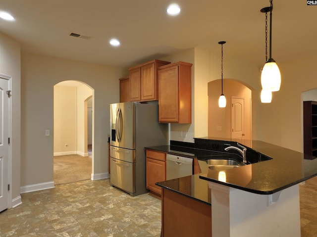 kitchen featuring stainless steel fridge with ice dispenser, pendant lighting, dishwasher, sink, and kitchen peninsula