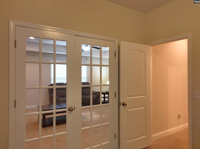 entryway featuring french doors and carpet flooring