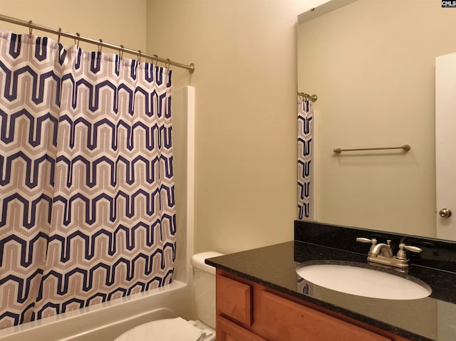 full bathroom with vanity, shower / bath combination with curtain, and toilet